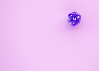 Purple cube for rpg on a pink background with space for text