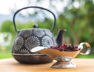 Foto op Aluminium Kettle and gravy boat with dry tea in the garden. Selective focus, bokeh © Aliona Ryne
