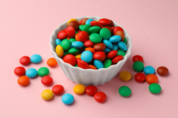 Tasty colorful candies on pink background, closeup