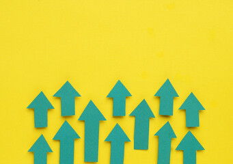 Paper arrows on yellow background, flat lay. Space for text