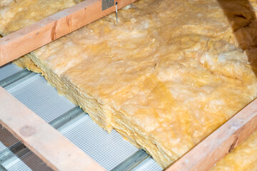 insulation of the house under the roof with the help of glass wool