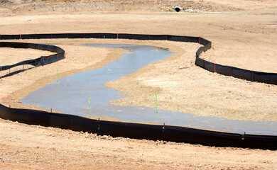 Abstract construction site with water flowing between cloth barricades
