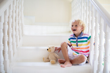 Kids on stairs. Child moving into new home.