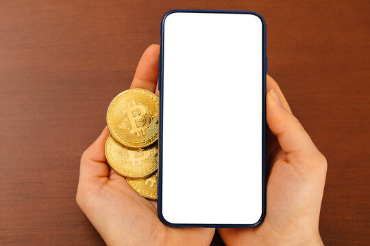 Mockup pay with bitcoin, woman with mobile phone and golden coin and bitcoin in hands