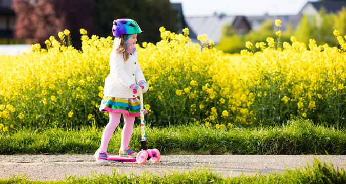 Child riding schooter on way to school