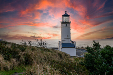 North head lighthouse at a headland at sunset on the south Washington state coast