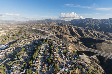 Aerial cityscape view of suburban sprawl in the Santa Clarita community of Los Angeles County, California. - obrazy, fototapety, plakaty