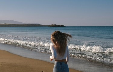 Young woman running along the beach of the sea or ocean and enjoy holiday at coast with on sunset. Amazing beautiful sunset at paradise beach in travel on the seashore. Running on a sandy beach