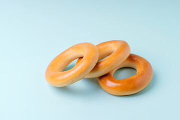 Three yellow calachas bagel lie on a blue background.