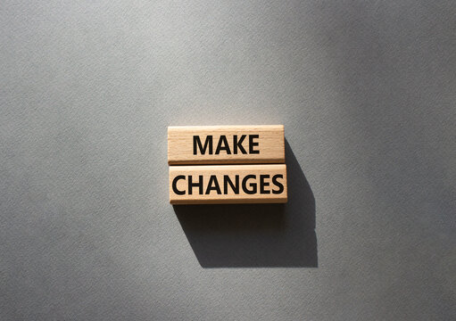 Make changes symbol. Wooden blocks with words Make changes. Beautiful grey background. Business and Make changes concept. Copy space.