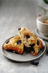 Homemade Blueberry breakfast scones served with cappuccino, selective focus