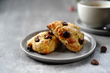Homemade Blueberry breakfast scones served with cappuccino, selective focus - obrazy, fototapety, plakaty