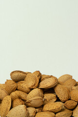Whole almonds in shell closeup against white background.