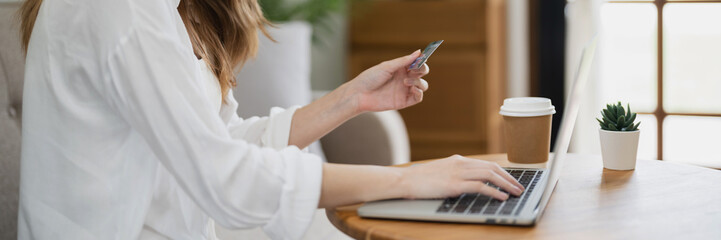 Happy asian woman using laptop and credit card for online payment, E-commerce