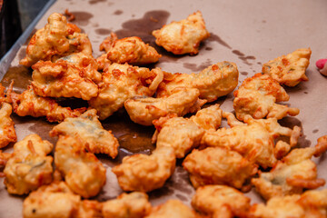 Fried chicken meat in oil dries on a sheet of paper. Fast food