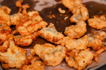 Fried chicken meat in oil dries on a sheet of paper. Fast food