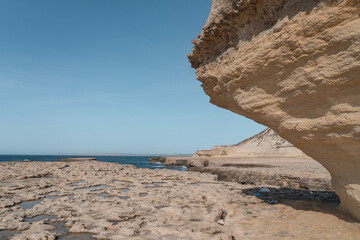 Roman era salt pans with eroding sandstone on the coastline of Malta