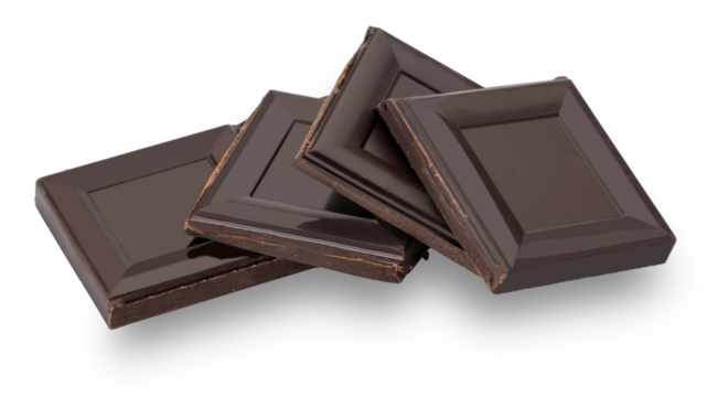 Square pieces of black chocolate bar stacked