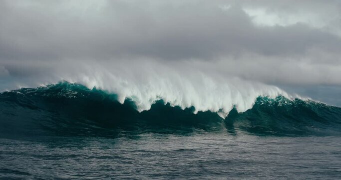 Large powerful ocean wave breaking in deep water, slow motion, power of nature, dramatic ocean storm