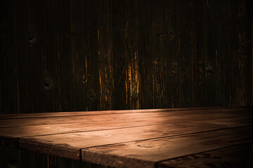 image of a wooden table on an abstract dark background with light in the center