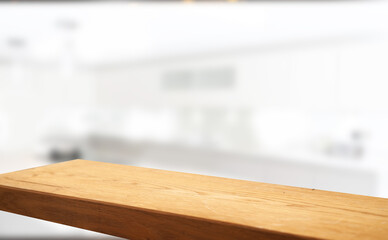 Wooden table top on blurred cafe showcase with light bulb. Background for product display montage or key visual design, abstraction