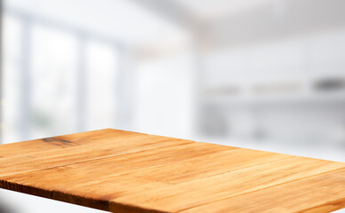 Wooden table top on blurred cafe showcase with light bulb. Background for product display montage or key visual design, abstraction