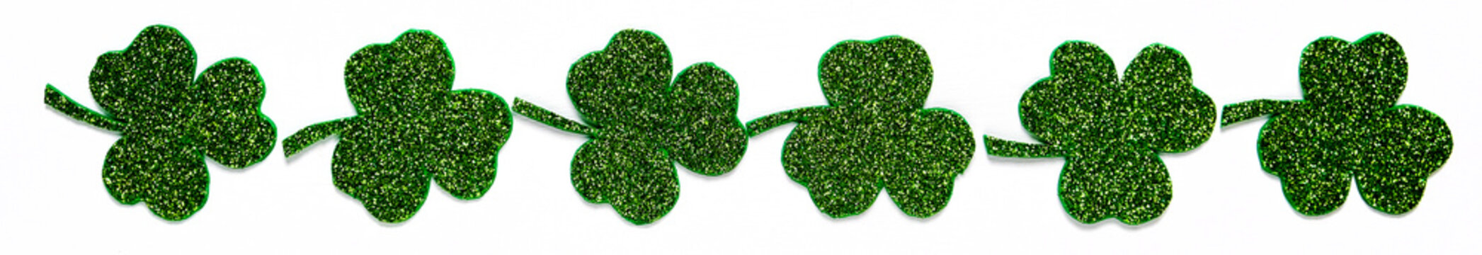 Happy St. Patrick's Day Banner.Holiday Background.St Patricks Day Frame Against A White Background. Flat Lay Shamrocks.Copy Space.Patrik's Day Banner