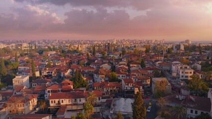 Fototapeta na wymiar View over the red roofs and medieval wall of the old city. Sunset. Panorama. Aerial drone view