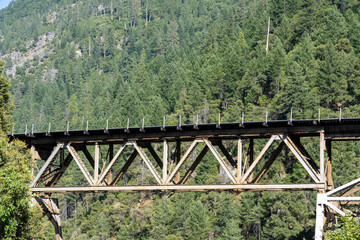Close up view of the Merlin Railroad Bridge with the mountains in background located in the Plumas...