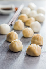Fototapeta na wymiar Xiaolongbao, traditional steamed dumplings. Xiao Long Bao buns on kitchen table.