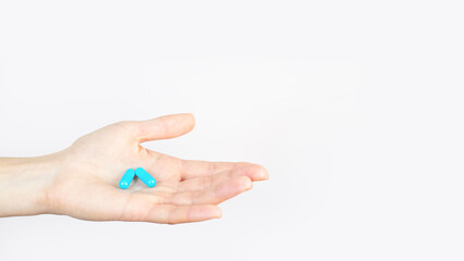 Blue capsules lies in human hand isolated on white background Medical Treatment Pharmacy Health