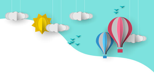Cute papercut sky landscape background with white copy space. Hot air balloon, sun and clouds made in realistic paper craft art or origami style for baby nursery, children design.