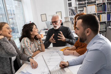 Day in a design studio. Group of designers and architects on meeting.	
