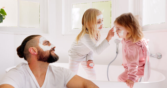 Father, girl kids and face mask in bathroom in for comic bonding, smile and happy together for skincare. Happy, dad and daughter children with cream, facial and beauty for skin with funny happiness