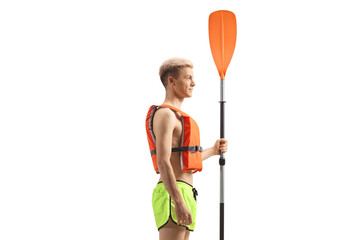 Profile shot of a young man with a life vest and a paddle