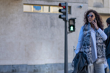 Fototapeta na wymiar Businesswoman Waiting Besides A Traffic Light