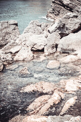 Sea stoney beach on sun day. Stone coastline. Rocky beach seascape for publication, poster, calendar, post, screensaver, wallpaper, postcard, banner, cover, website. Vertical high quality photo