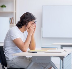 Young male student in front of whiteboard