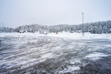 Icy parking lot and deep snow.