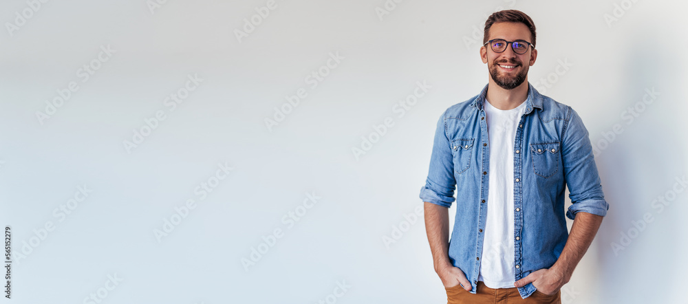 Wall mural Isolated shot of young handsome man with beard, wearing casual clothes, posing in studio on white background