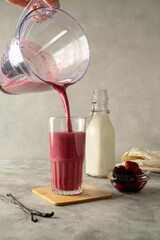 Pouring berry, pink smoothie drink with fresh fruits