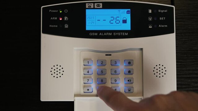 A man disarms a house by dialing a code. GSM signaling. Up close