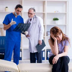 Fototapeta premium Two doctors examining young woman