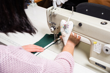 Obraz na płótnie Canvas Seamstress works in the tailoring workshop