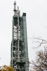 Oil and gas processing tower on a background of grey sky