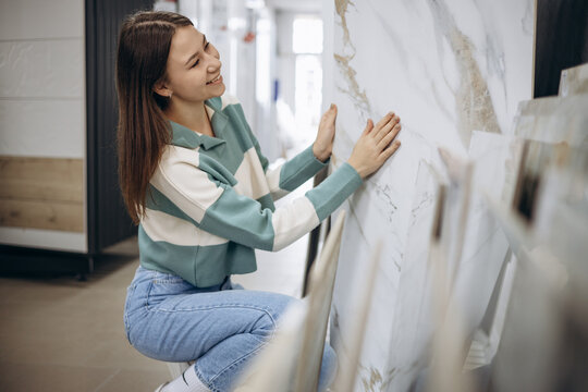 Woman looking for tiles at building market