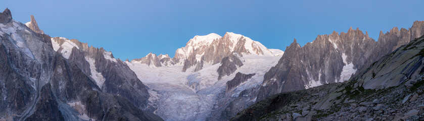 The panorama of Mont Blanc massif and Aiugulles towers in the morning dusk.