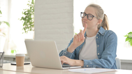Rejecting Beautiful Young Woman Waving Finger in Denial while using Laptop