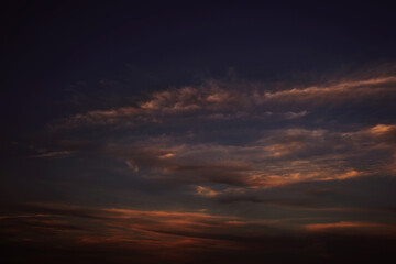 Fototapeta na wymiar Orange red sunset. Dark violet blue evening sky with clouds. Background for design. Dramatic skies.