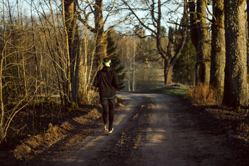 Obraz premium Man running in spring sunset 